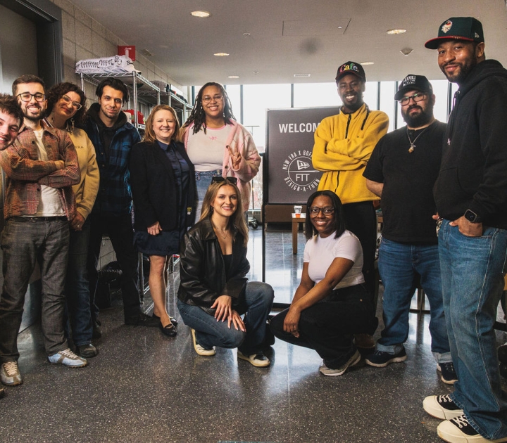A group of students standing in front of a sign that reads Welcome to New Era Buffalo State Design a Thon