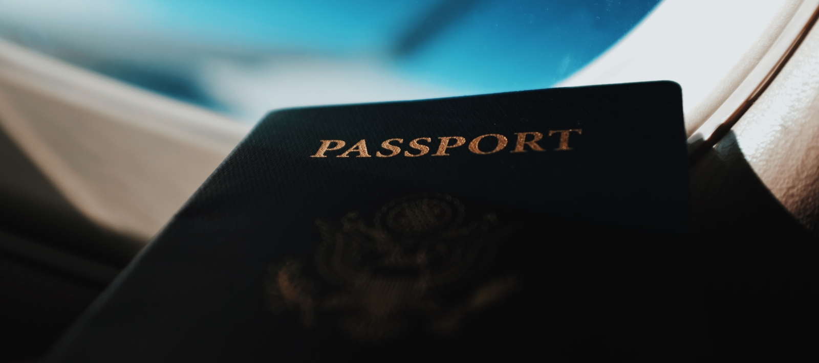 Passport resting on airplane window